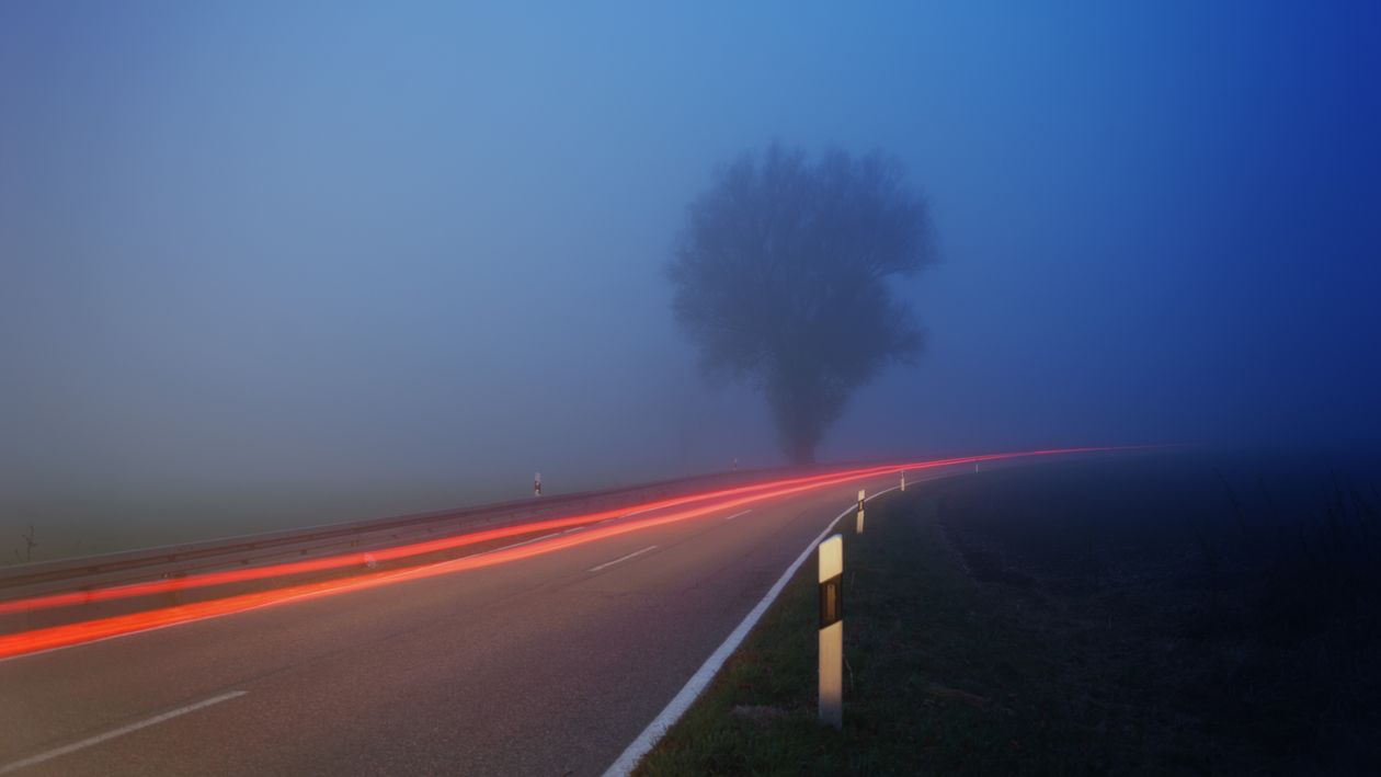 Foggy highway at dusk - roads between alternate realities