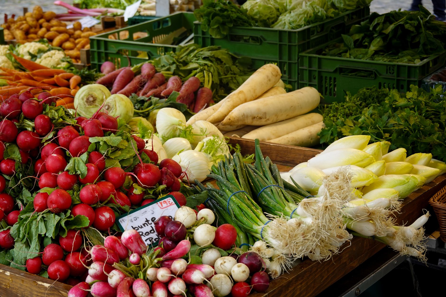 Fresh organic vegetables at a farmer's market, the certified-organic model that human-made certification mirrors in the AI era