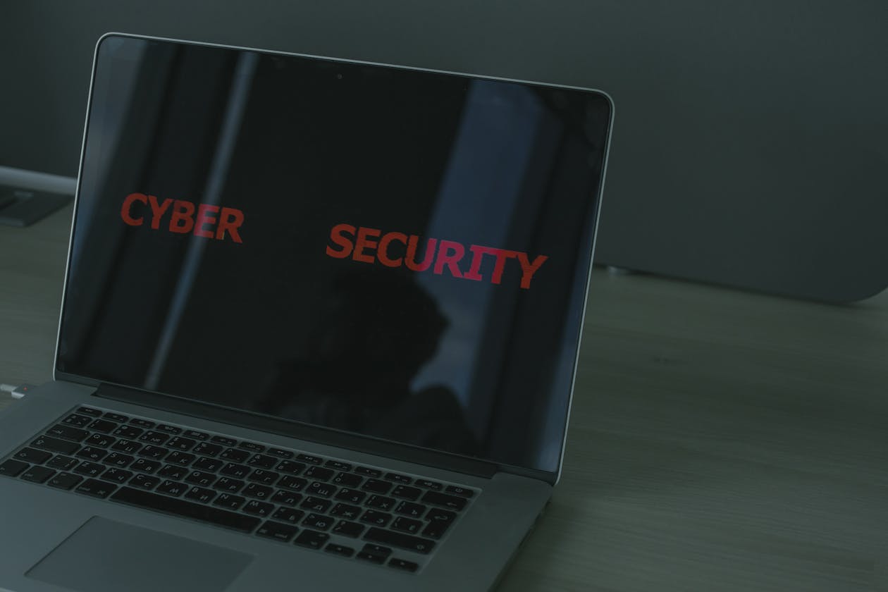 Cybersecurity laptop showing digital threats from CCP political infiltration and POGO cyber attacks