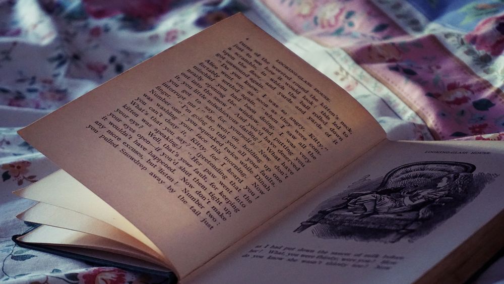 An open book resting on a warm wooden surface